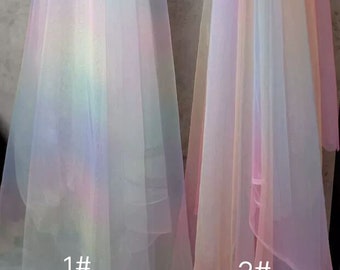 May include: Two sheer fabric swatches with iridescent rainbow colors. The swatch on the left is labeled "1#" and the swatch on the right is labeled "2#"