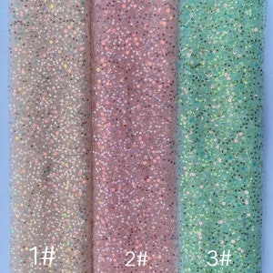 May include: Three swatches of iridescent sequin fabric in different colors: light silver, light pink, and light blue. The swatches are labeled 1#, 2#, and 3#.