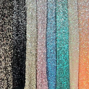 May include: A variety of sequin fabrics in different colors, including black, gold, pink, blue, turquoise, and orange. The fabrics are all made of sequins on a mesh backing.