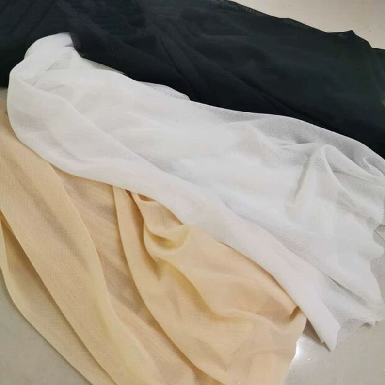 May include: Three pieces of sheer fabric in black, white, and beige. The fabric is soft and delicate, and it has a slightly textured surface.