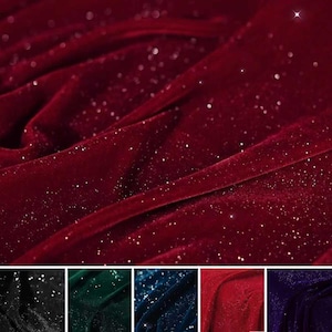 May include: A close-up of a deep red velvet fabric with a shimmering, glittery effect. The fabric is draped in soft folds, catching the light and creating a luxurious appearance. The image also shows a selection of other colors.