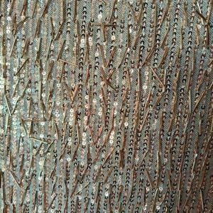 May include: A sheer fabric base featuring vertical rows of small, round, rose gold sequins interspersed with scattered, thin, metallic rose gold bugle beads arranged in a random, non-directional pattern across the entire surface of the material.