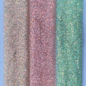 May include: Three rolls of iridescent sequin fabric in white, pink, and green. The fabric is sheer and has a delicate sparkle.