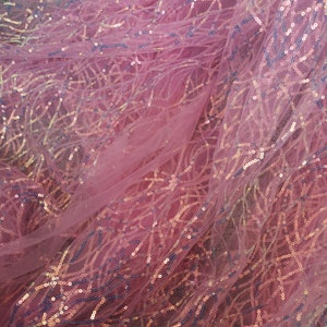 May include: Pink sheer fabric with iridescent sequins in a geometric pattern.