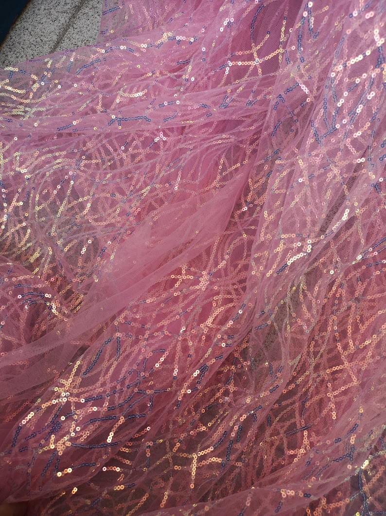 May include: Pink sheer fabric with iridescent sequins in a geometric pattern.