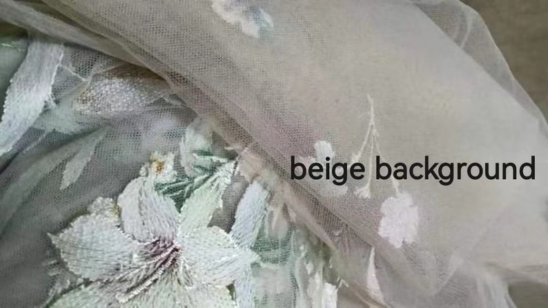 May include: White floral embroidery on a beige tulle fabric. The embroidery features delicate flowers and leaves.