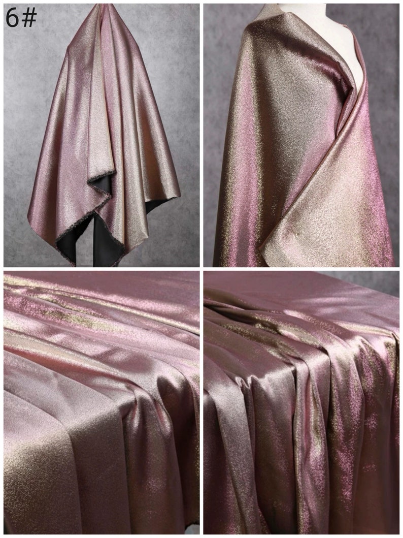 May include: A close-up of a metallic pink and gold fabric with a subtle shimmer. The fabric is draped and folded to show its texture and drape.