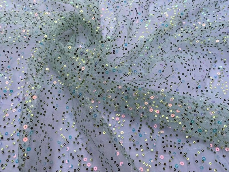 May include: Pale green tulle fabric with iridescent sequins in a scattered pattern.