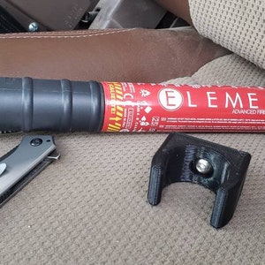 May include: A red fire extinguisher with the text "ELEMENT ADVANCED FIRE PROTECTION" on the side. The extinguisher is mounted on a black bracket. A yellow and black fire extinguisher is also visible in the image.