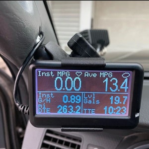 May include: A black digital display screen showing vehicle performance metrics. The screen displays data including instant MPG at 0.00, average MPG at 13.4, and other readings such as gallons and time to empty.