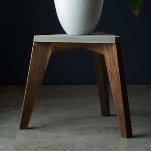 Accent table made of concrete and walnut wood