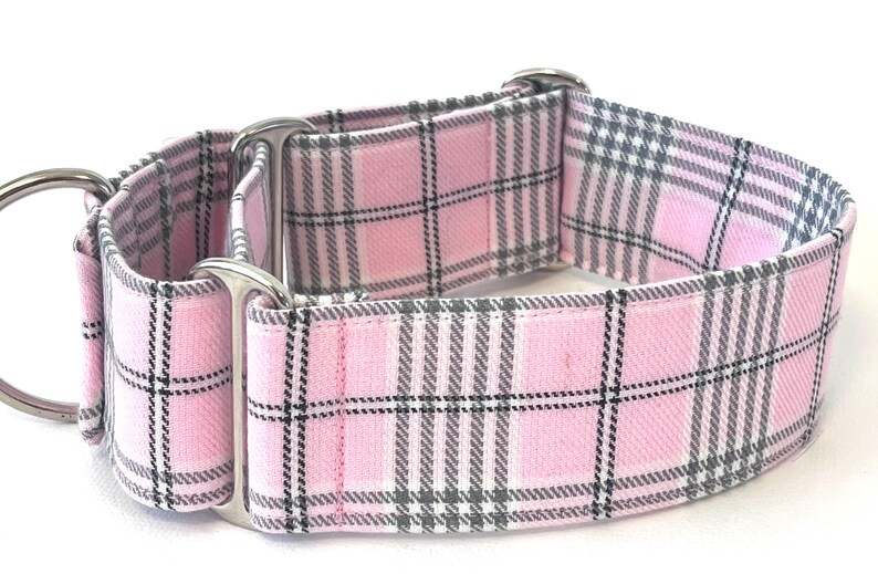 May include: A pink and gray plaid dog collar with silver hardware.