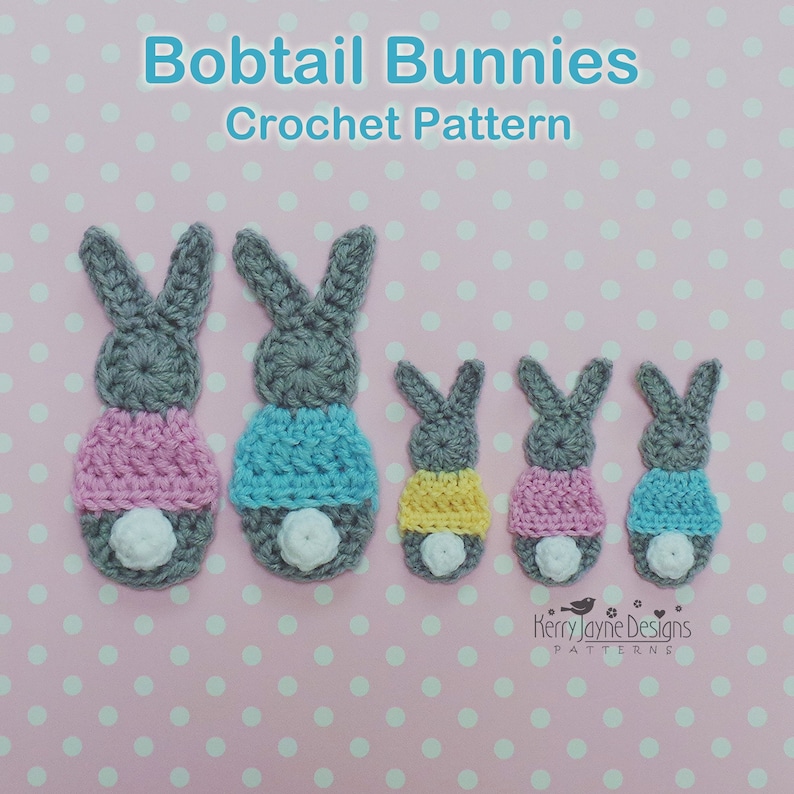 May include: Crocheted bobtail bunny pattern in various sizes. The bunnies are gray with colorful bottoms in pink, blue, and yellow, and white fluffy tails. The text "Bobtail Bunnies Crochet Pattern" is at the top.