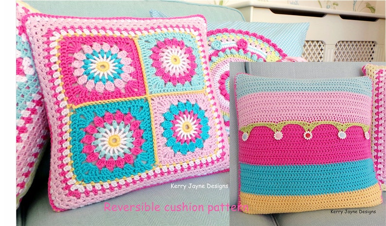 May include: Two crocheted pillow covers with reversible designs. One side features a pink, blue, and yellow square pattern with a flower motif. The other side features a pink, blue, and yellow striped pattern with a green and pink trim.