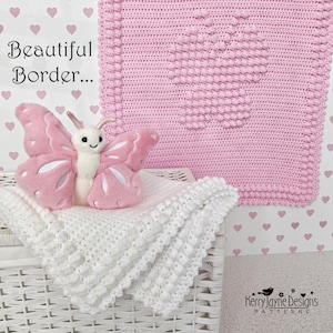 May include: A pink crocheted baby blanket with a butterfly design and a white crocheted blanket. A pink and white plush butterfly sits on the white blanket. The text "Beautiful Border..." is visible.
