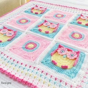 May include: A crocheted baby blanket with a pink, yellow, and blue color scheme. The blanket features a repeating pattern of owls and circles. The blanket is edged with a pink crocheted border. The text "Kerry Jayne Designs" is visible in the lower left corner of the image.
