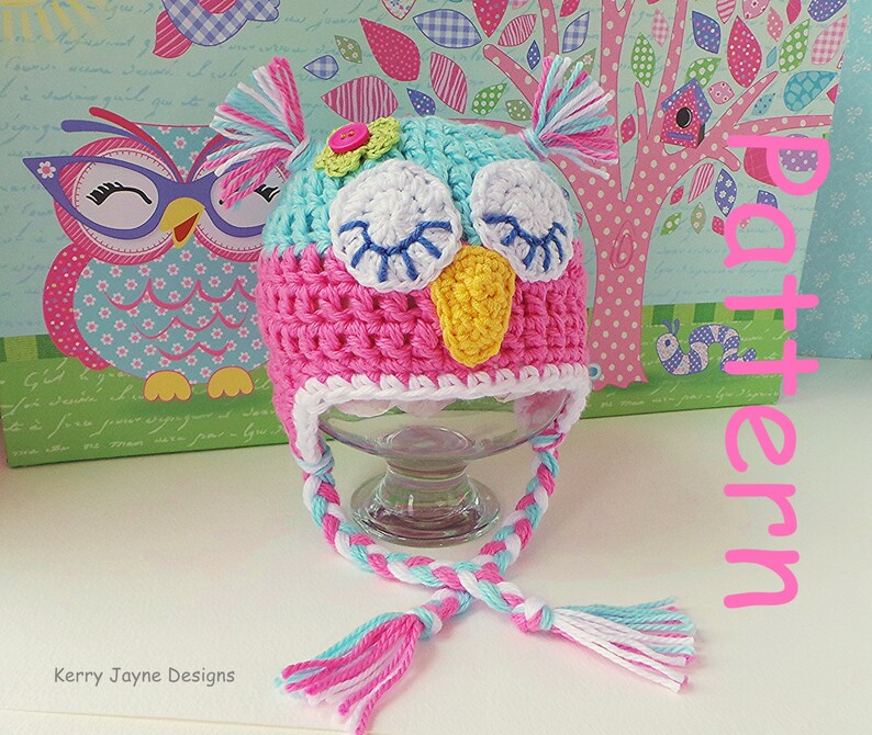 May include: A pink and blue crocheted owl hat with a white brim and a long braided cord. The hat has a yellow beak, white eyes, and blue eyelashes. The cord has pink, blue, and white tassels.