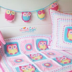 May include: A crocheted owl baby blanket, pillow, and toy basket set in pink, blue, and yellow. The set features a repeating owl design with flowers. The blanket is made of squares with different patterns, including a circle with a star in the center. The pillow is a square with an owl in the center. The toy basket is shaped like an owl with a pink, blue, and yellow color scheme. The set is perfect for a baby's nursery.