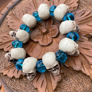 A spooky skull bracelet with blue glass jewellery