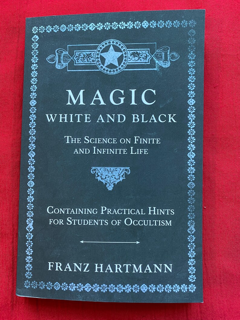 May include: A black book with a white border and a star design on the cover. The title is "Magic White and Black: The Science on Finite and Infinite Life. Containing Practical Hints for Students of Occultism." The author is Franz Hartmann.