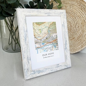 May include: A framed map print with a white distressed wood frame. The map shows a detailed area with the text "OUR HOME" and the address "24 West Helen Street". The map is in shades of green, brown, and blue.