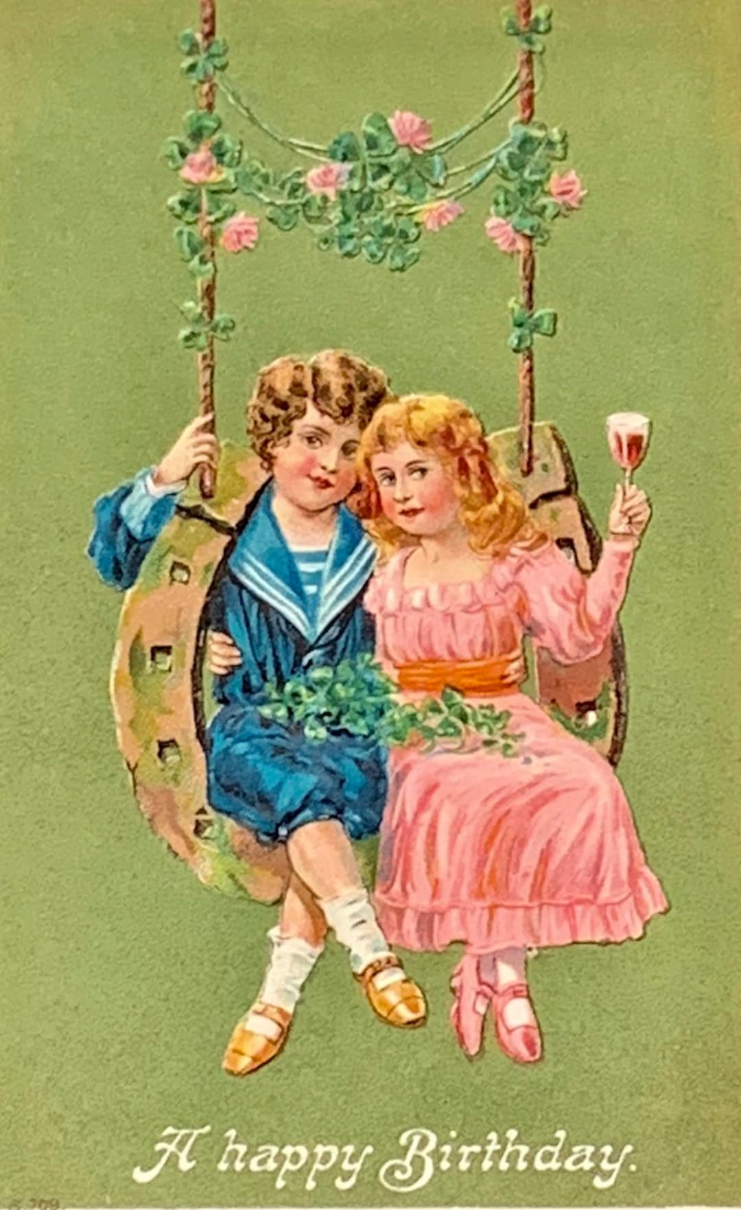Antique Embossed Birthday Postcard: Boy, Girl on Horseshoe Swing