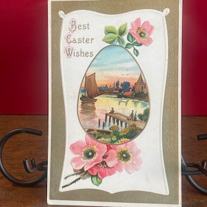 EA66G, Postal de Pascua antigua en relieve de la década de 1900: Escena tranquila de un lago con un barco, Hombre pescando, Flores rosas, Mis mejores deseos de Pascua