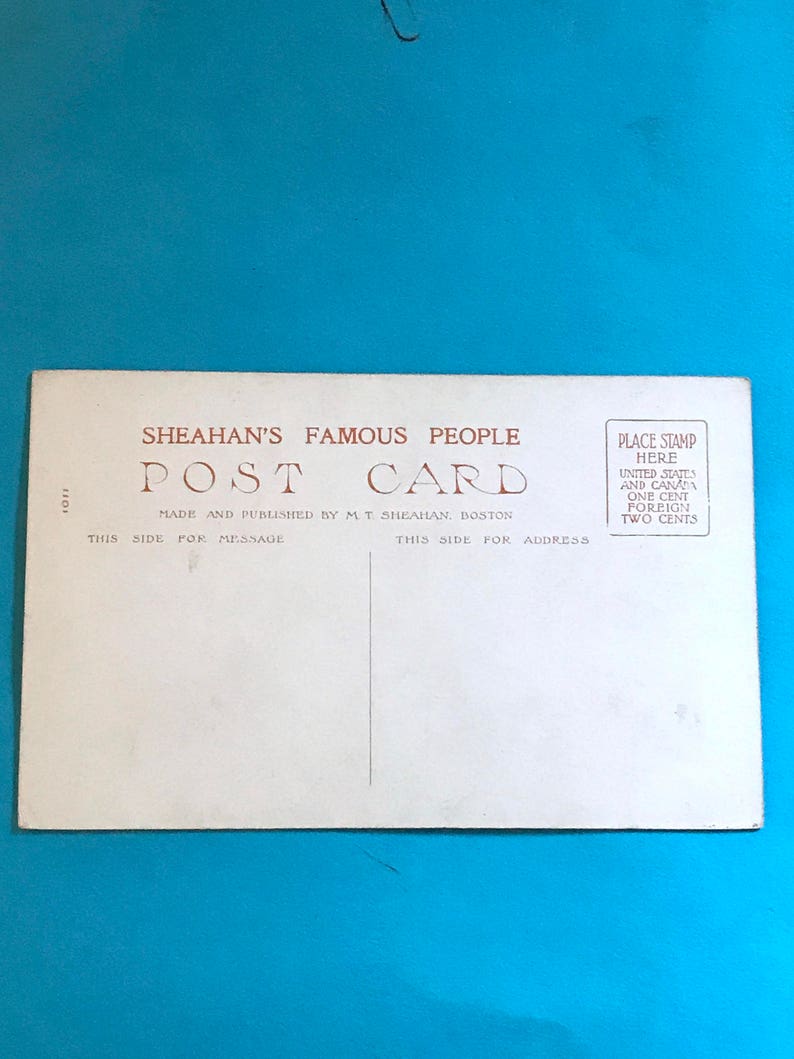 May include: A vintage postcard with the text "SHEAHAN'S FAMOUS PEOPLE POST CARD" and "MADE AND PUBLISHED BY M.T. SHEAHAN, BOSTON". The postcard has instructions for placing a stamp and the cost of postage for the United States and Canada, and for foreign countries.