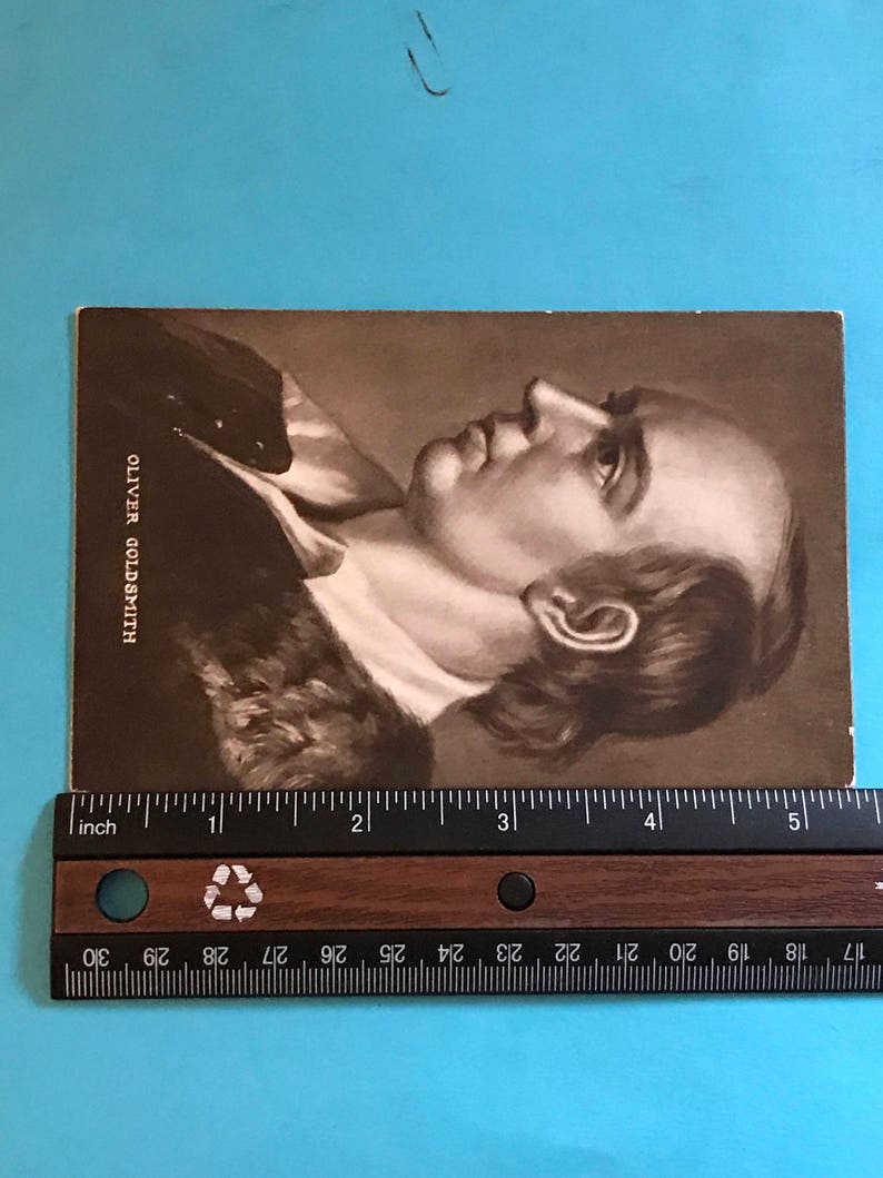 May include: A black and white portrait of Oliver Goldsmith, a famous Irish writer and poet. The image is printed on a card.