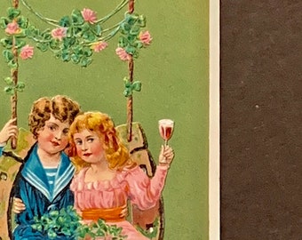 Antique Embossed Birthday Postcard: Boy, Girl on Horseshoe Swing