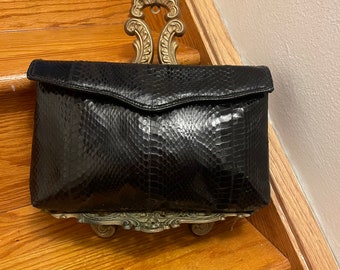 Black snake skin clutch made by Magnum  with strap