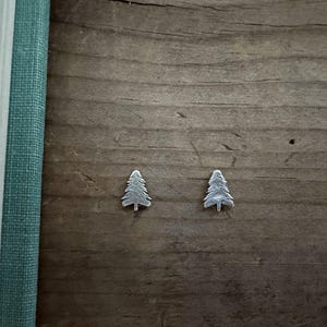 May include: A rustic wooden sign with the text "Welcome to our home" in white lettering. The sign features a distressed finish and a simple, inviting design, perfect for a front porch or entryway.