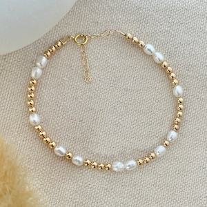 14k Gold filled and freshwater PEARL alternating Bead Bracelet. GENUINE Freshwater Pearl Bracelet. 1" ADJUSTABLE Chain and 5.5MMspring ring closure.