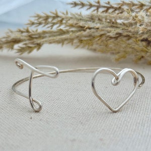 Sterling Silver 16 gauge wire initial heart bangle, hand shaped and formed, on linen display