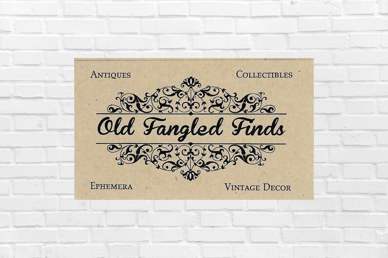 K&ouml;nnte beinhalten: Ein rechteckiges beiges Schild mit dem schwarzen Text Old Fangled Finds in Schreibschrift, zentriert zwischen kunstvollen schwarzen Schn&ouml;rkeln. Die W&ouml;rter Antiques und Collectibles stehen oben, Ephemera und Vintage Decor unten.