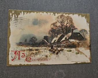 May include: Vintage Christmas postcard featuring a winter scene with a snow-covered village and sheep. The postcard has the text "A Joyous Christmas" in red and white script. The edges of the postcard have a gold border.