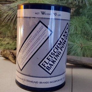 May include: A vintage tin can of Fleischmann's Baking Powder, a phosphate powder, with blue and white stripes and text. The can is labeled with a net weight of 10 lbs. and is manufactured by Standard Brands Incorporated.
