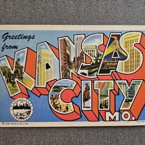 May include: Vintage postcard with the words "Greetings from Kansas City MO" in large, colorful, 3D block letters. The letters are filled with images of the city, including buildings and landmarks. The postcard has a blue background.