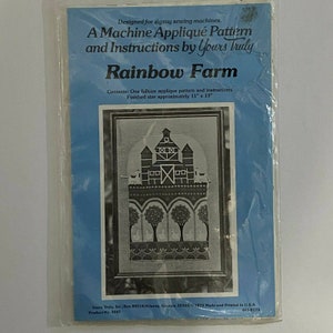 May include: A black and white applique pattern for a rainbow farm with a farmhouse, trees, and birds. The pattern is designed for zigzag sewing machines and measures approximately 11 inches by 19 inches.