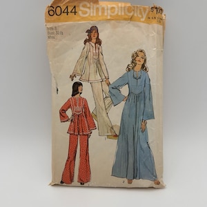 May include: Vintage Simplicity sewing pattern 6044. The pattern features illustrations of three different outfits: a white pantsuit, a red dotted pantsuit, and a long blue dress. The pattern is for a Miss size 8 with a 31 1/2 inch bust.