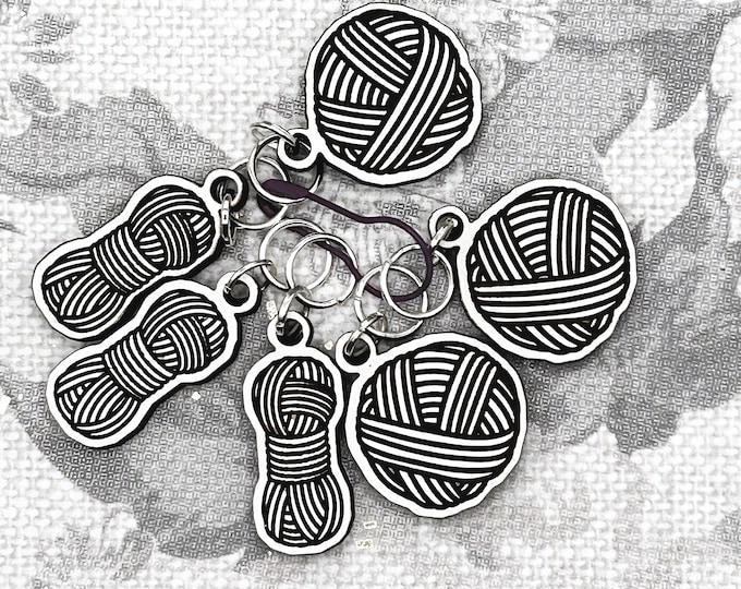 Yarn balls and skeins stitch markers for knitting or crocheting.