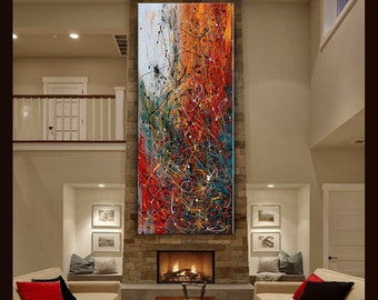 May include: Abstract painting with a mix of red, orange, yellow, blue, green, and black paint splatters and lines. The painting is hanging above a fireplace in a living room.