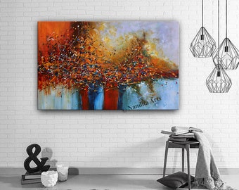 May include: Abstract painting with a mix of orange, blue, red, and yellow colors. The painting features a swirling, organic design with a textured surface. The painting is signed "Nandita Arts" in the bottom right corner.