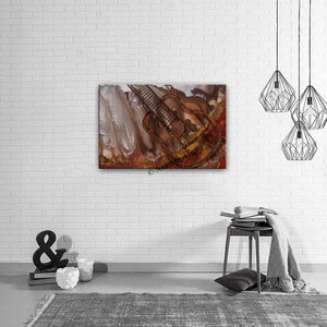Abstract painting of a guitar with brown, red, and white paint. The guitar is in the center of the painting and is surrounded by abstract shapes and lines.