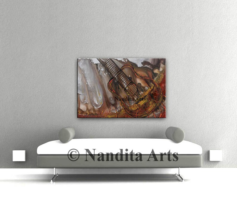 Abstract painting of a guitar with red, orange, and brown paint. The guitar is in the center of the painting and is surrounded by abstract shapes and lines. The painting is on a white wall and is framed in a black frame. The painting is titled 'Guitar' and is signed by the artist 'Nandita Arts'.