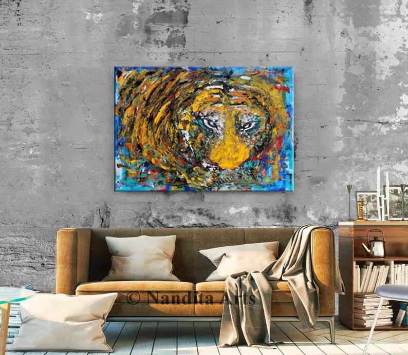 May include: Abstract painting of a lion's face in shades of yellow, blue, and brown. The lion's eyes are prominent and the painting has a textured, brushstroke effect.