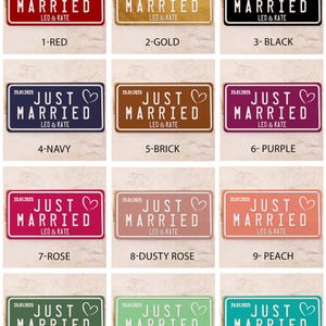 May include: A selection of rectangular signs in different colours, each bearing the text "JUST MARRIED" and a heart symbol. The signs also display the date "25.01.2025" and the names "LEO & KATE".