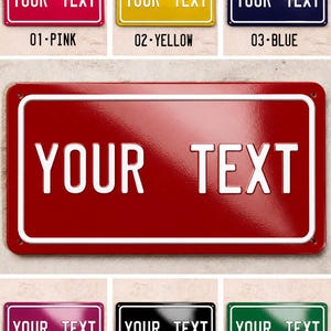 May include: A selection of rectangular metal signs in various colours, including pink, yellow, blue, red, purple, black, and green. Each sign displays the text "YOUR TEXT" in white, with a number and colour name below.