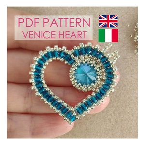 May include: PDF pattern for a beaded heart with a turquoise and silver colour scheme. The heart is made with seed beads and a larger turquoise crystal in the centre. The pattern is available in English and Italian.