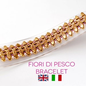 May include: A gold and pink beaded bracelet with a woven design. The bracelet is labeled "FIORI DI PESCO BRACELET" with the flags of the United Kingdom and Italy.